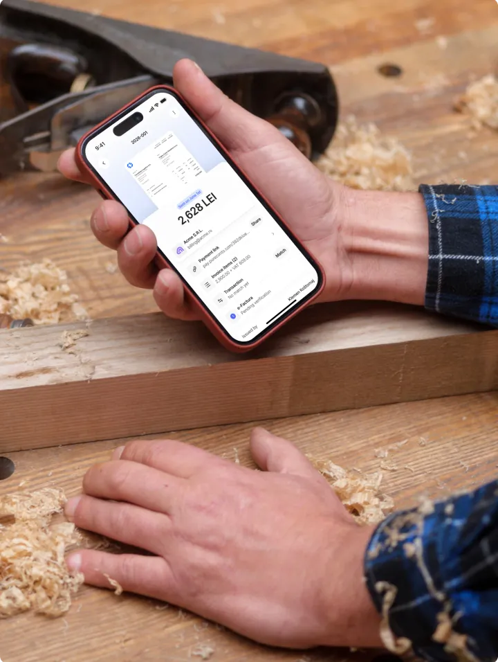 Person holding a phone with Pureconto at a job site